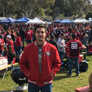 San Francisco 49ers jacket being worn at a lively outdoor tailgating event.