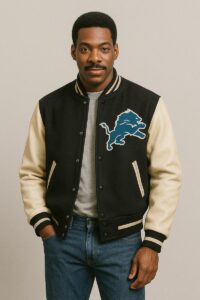 A man modeling the modern replica of the Axel Foley jacket with a Detroit Lions logo, hands in pockets.