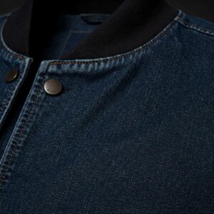 Close-up view of the durable denim fabric of a bomber jacket.