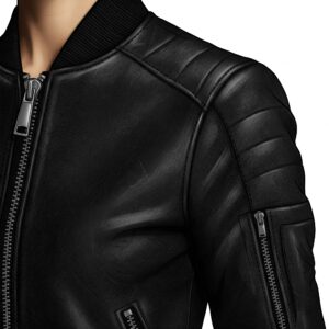 Close-up of a black leather bomber jacket showing shoulder stitching, zippers, and texture. 