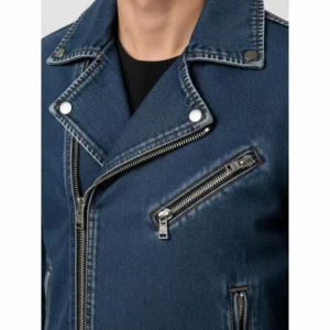 Close-up shot of a men's denim moto jacket, highlighting the intricate stitching, zipper details, and classic collar design.