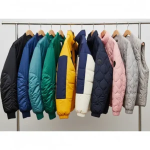 A collection of various quilted jacket styles and colors displayed on hangers, including bomber, puffer, and gilet designs, suitable for men and women.