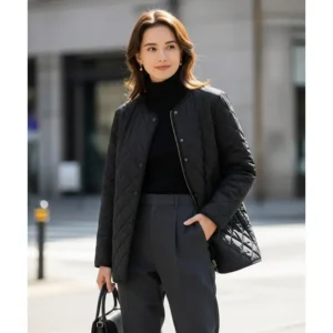 A woman pairing a tailored black quilted jacket with smart trousers, illustrating how this versatile outerwear can elevate a smart-casual ensemble.
