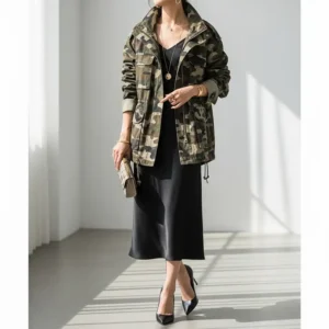 A women's camo jacket styled in a dressier outfit, showing how it can be incorporated into more elevated looks.