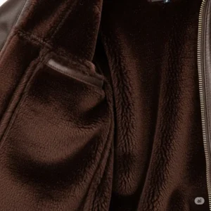 Detail of the soft interior lining and rich texture of a premium women's leather flight jacket, emphasizing comfort and quality.