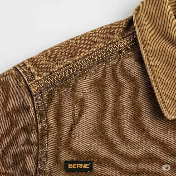 Close-up of the robust fabric and reinforced stitching on a Berne jacket, highlighting its quality and durability.