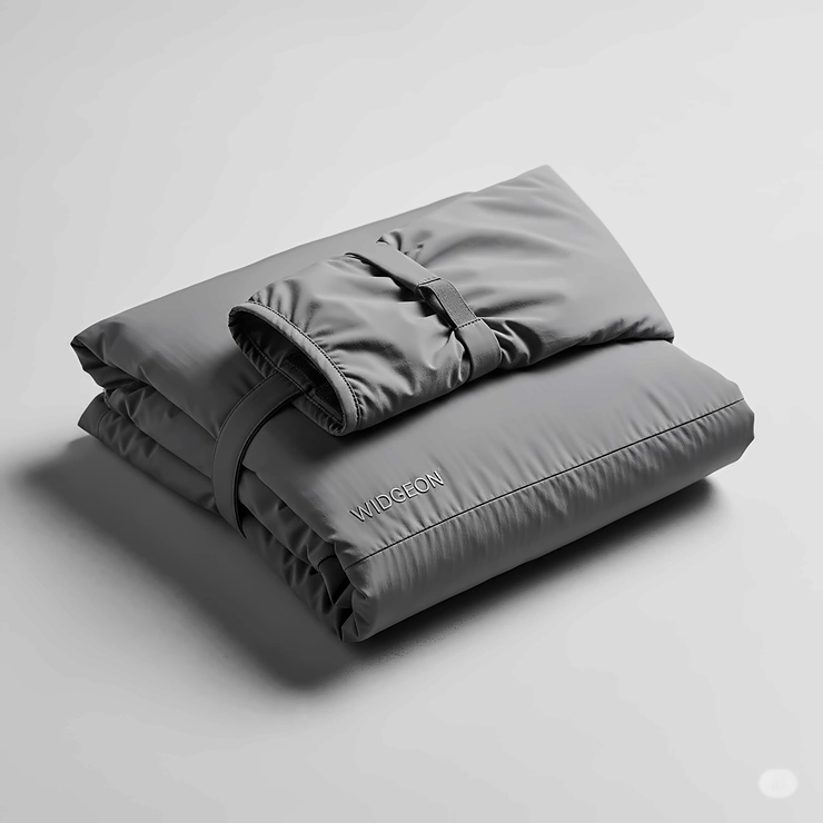 A neatly folded widgeon jacket, demonstrating its compact design for easy packing and travel.