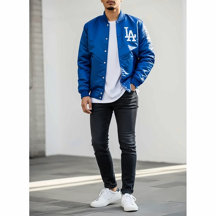 A fashion guide showing how to style a Dodgers satin jacket with jeans and sneakers.
