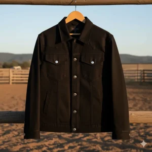 Full view of a sleek black cowboy jacket with a straight collar and yoke seams, suitable for rodeo wear.