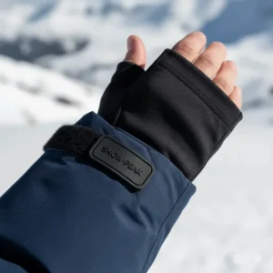 Detail shot of the adjustable wrist cuffs and thumb-hole wrist gaiters on the sleeve of an insulated ski jacket.