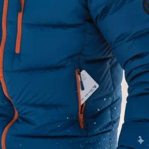 Detail of waterproof zippers and practical pockets, including a ski pass pocket, on the ski puffer jacket.