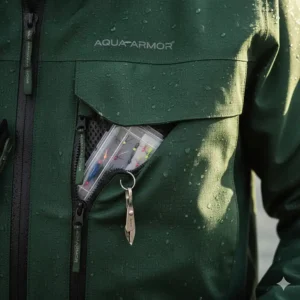 Close-up of the large, secure, zippered chest pocket on the waterproof wading jacket designed for fly box storage.