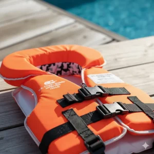 The front view of the newborn PFD showing the heavy-duty zipper and main chest buckle for a secure fit.