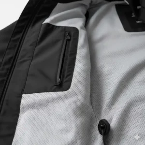 Interior view showing the breathable mesh lining and inner pocket of a women's black rain jacket.