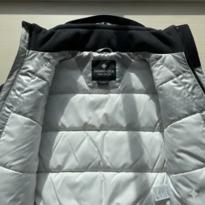 Detailed view of the interior lining and insulation for a warm youth snowboard jacket designed for cold weather riding.