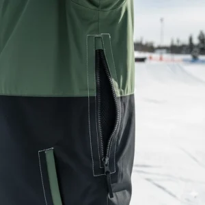 Detailed view of mesh-lined pit zips on a snowboard jacket to maintain breathability during intense park sessions.