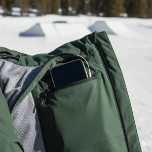 Internal pocket of a snowboard jacket designed to securely hold a phone or music player for park laps.