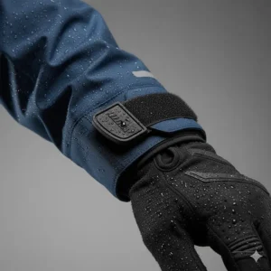 Velcro adjustable wrist cuffs on a waterproof jacket designed to fit over cycling gloves.