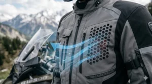 Close-up illustration of mesh airflow vents on an adventure textile jacket for cooling.