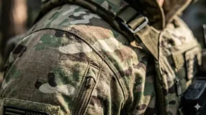 Close-up illustration of the durable ripstop fabric pattern on a MultiCam tactical jacket showing reinforced stitching.
