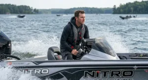 Tournament angler wearing an ergonomic bass fishing life vest designed for high-speed boating.