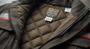 Interior thermal lining close-up view of a certified FR insulated jacket showing quilted flame-retardant insulation.