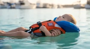 Neoprene baby life vest with ergonomic neck support collar and adjustable chest straps.