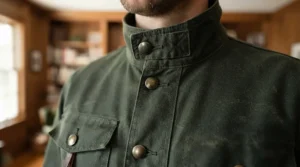 Close-up of a military style jacket men in olive green with brass buttons