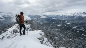 Hiker looking at a snowy mountain range while testing out the best parka men for winter.