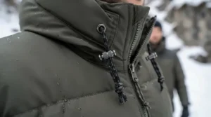 Close-up of fabric details on the best winter parka men designed to withstand extreme cold weather climates.
